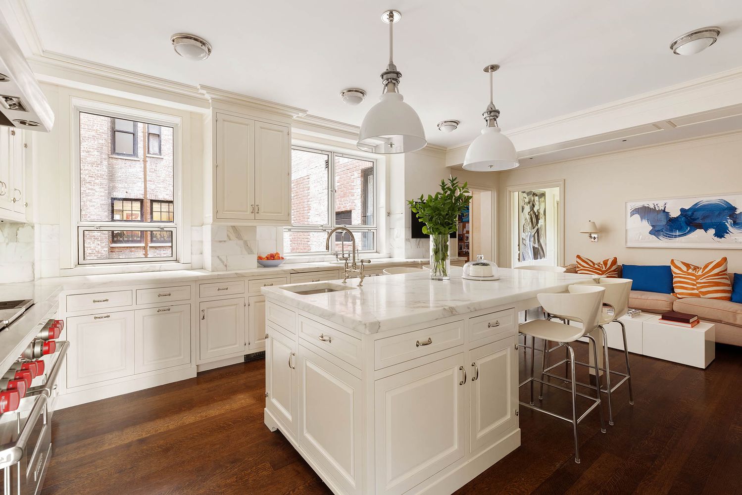 a large white kitchen with a large island