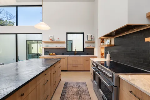 a kitchen with a sink stove and cabinets