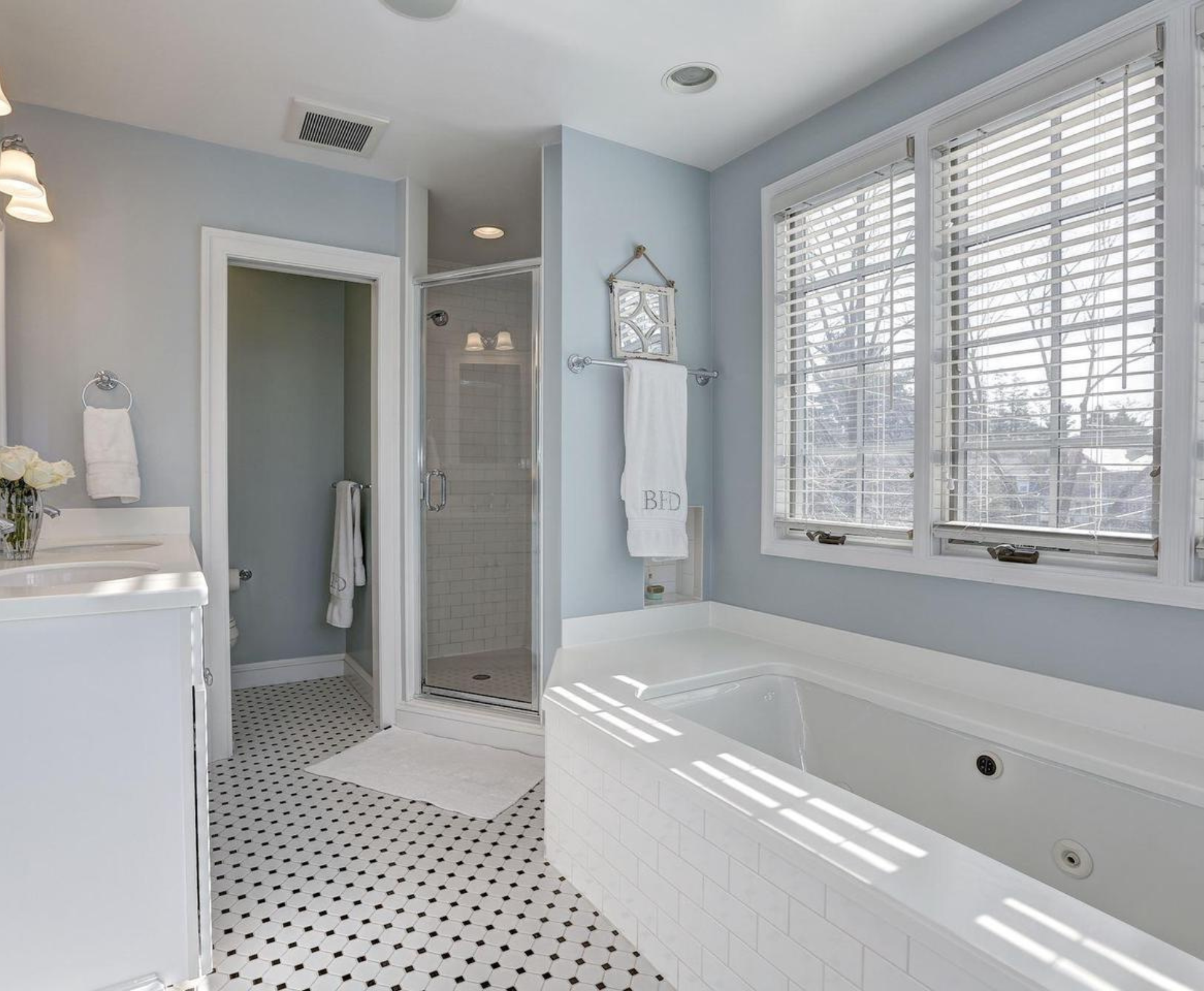 5002 Allan Road Bethesda, MD 20816 - Photo 8 of 9 a bathroom with a bathtub a shower a sink and a window
