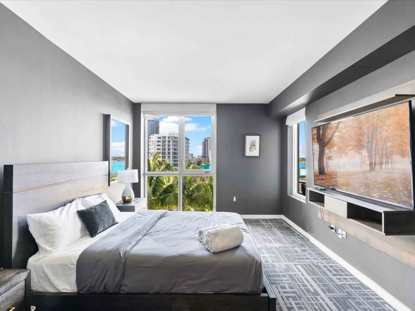 a bedroom with a bed and a large window