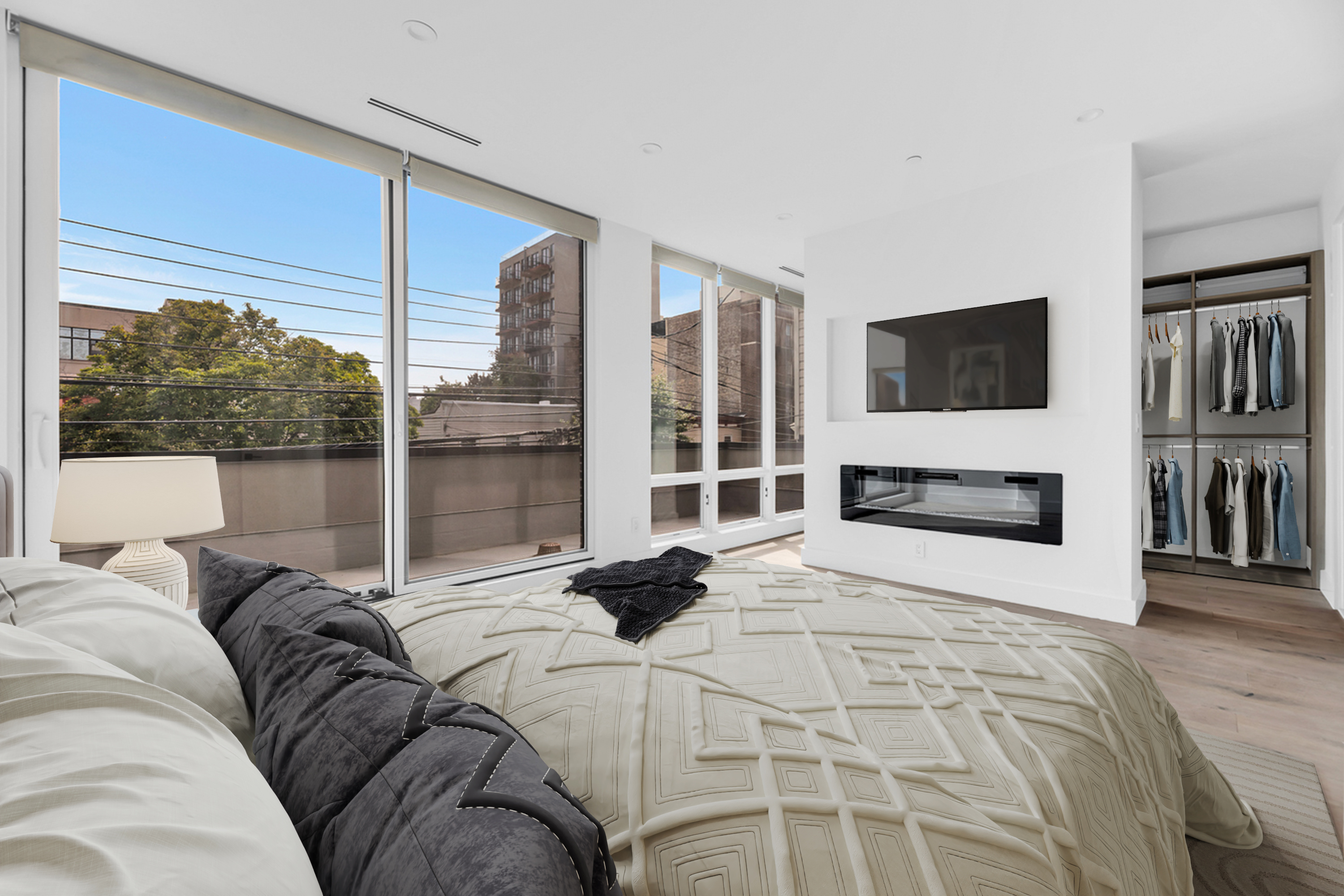 38-26 29th Street, Unit 2 Queens, NY 11101 - Photo 6 of 14 a bedroom with a bed a television and a large window