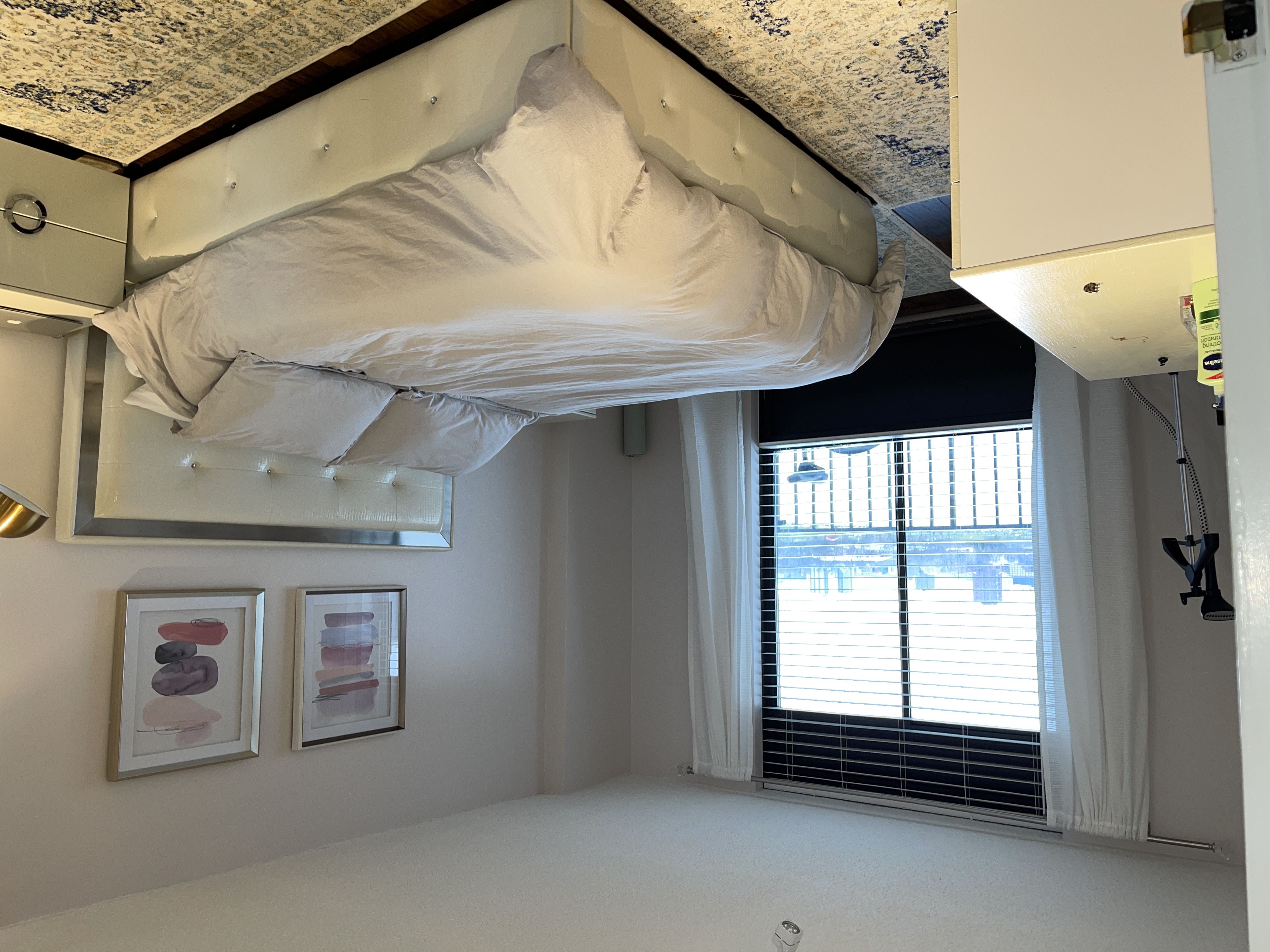 25-40 Shore Boulevard, Unit 8T Queens, NY 11102 - Photo 13 of 23 a bedroom with a bed and window