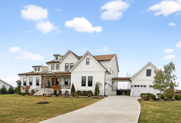 a front view of a house with a yard swimming pool and outdoor space