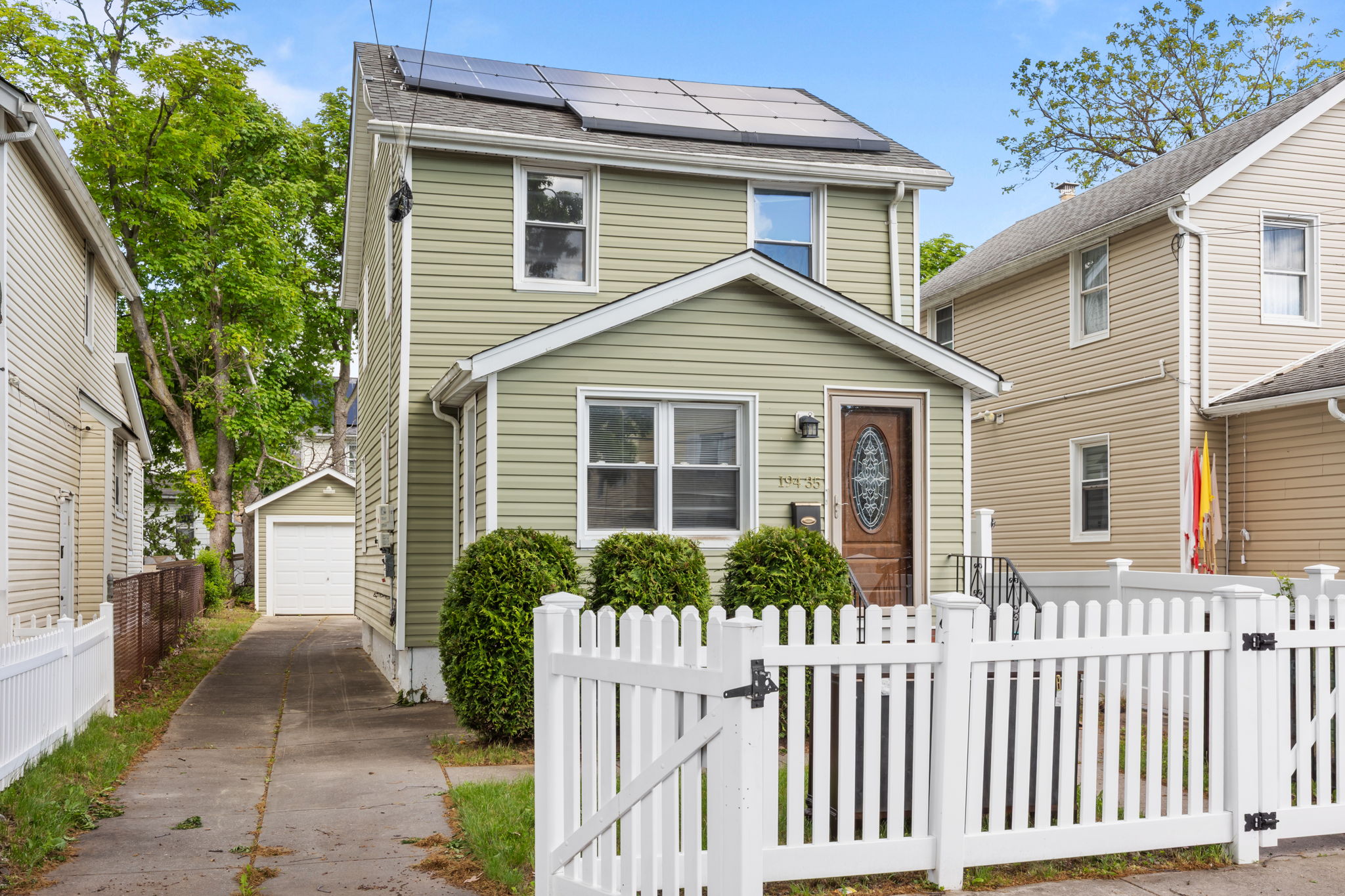 194-35 114th Drive Queens, NY 11412 - Photo 15 of 21 a front view of a house with a garden
