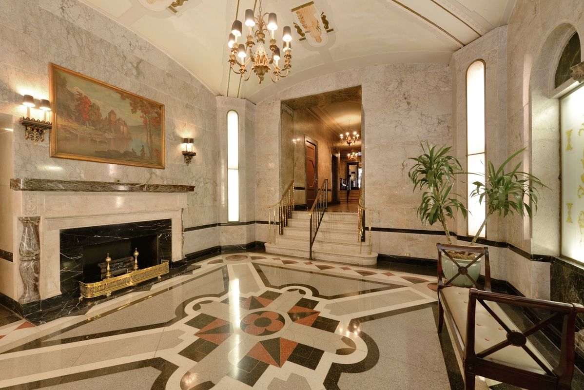 7 Park Avenue, Unit 7J Manhattan, NY 10016 - Photo 6 of 8 a living room with furniture and a fireplace