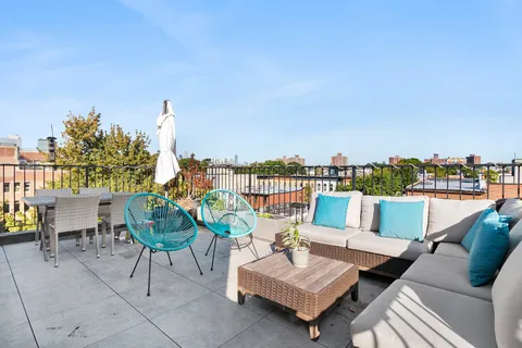 a view of a chairs in patio with a lake view