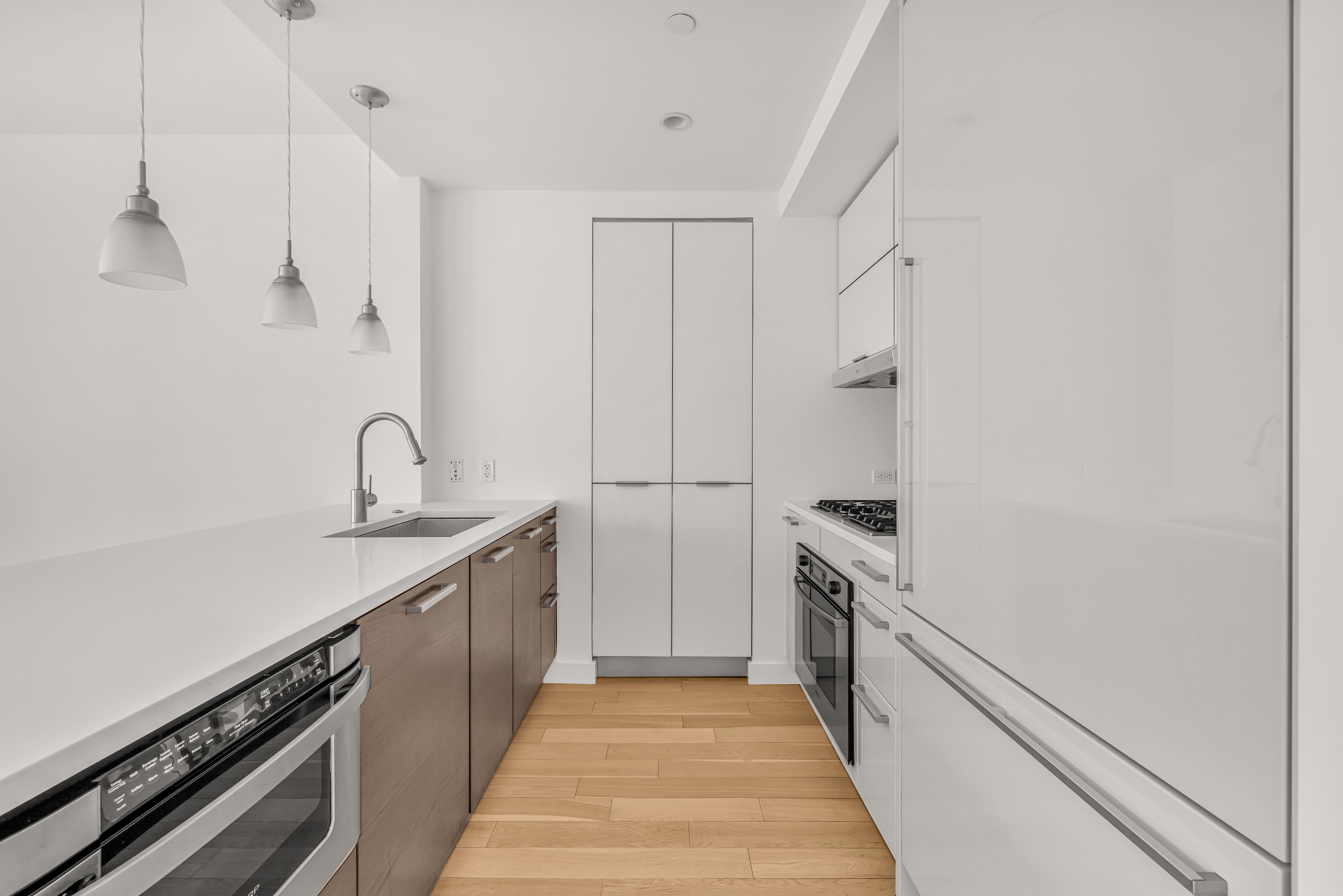 34 North 7th Street, Unit 3Z Brooklyn, NY 11249 - Photo 3 of 14 a kitchen with a sink and stainless steel appliances