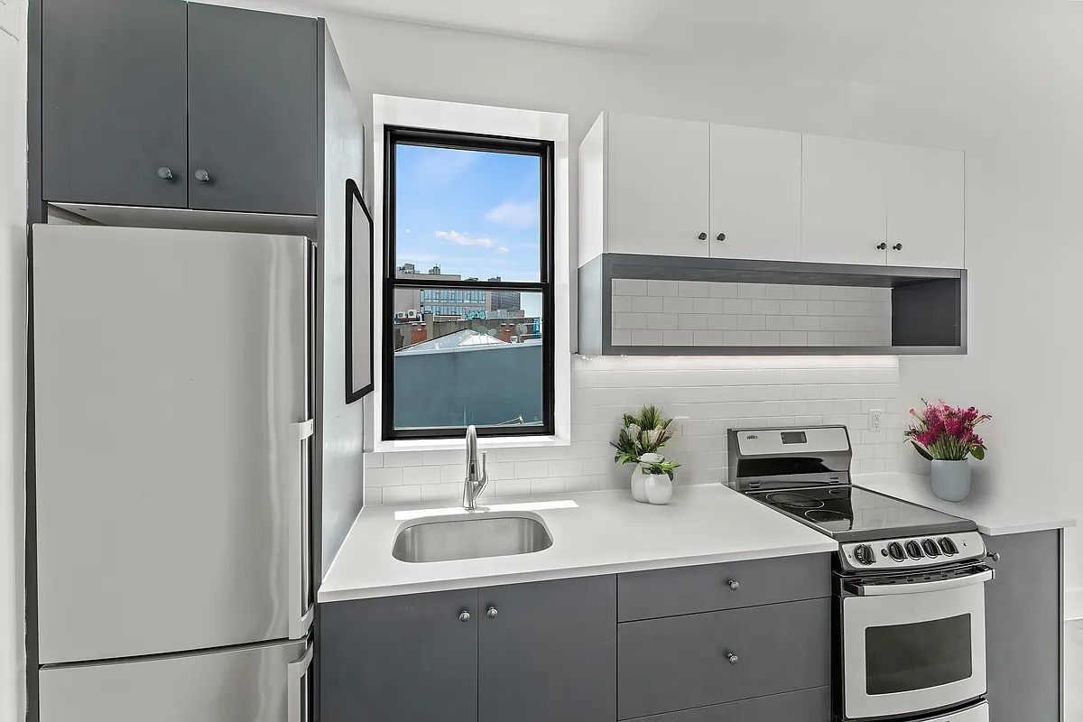 30 Belvidere Street, Unit PH4 Brooklyn, NY 11206 - Photo 3 of 8 a kitchen with stainless steel appliances a sink stove and cabinets