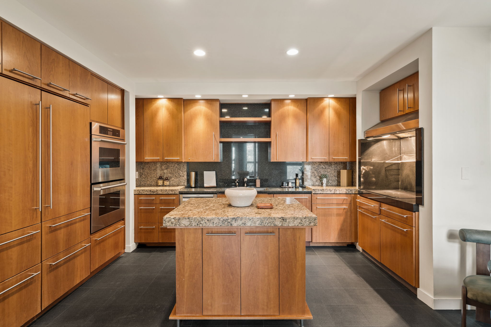 1820 Rittenhouse Square, Unit 601 Philadelphia, PA 19103 - Photo 2 of 4 a kitchen with stainless steel appliances granite countertop a refrigerator a sink dishwasher a stove and white countertops with wooden floor