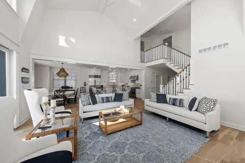 a living room with furniture and a chandelier