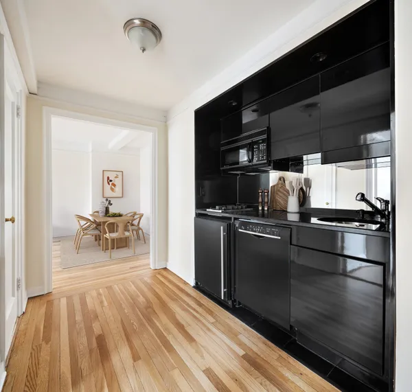 a kitchen with a refrigerator and a table