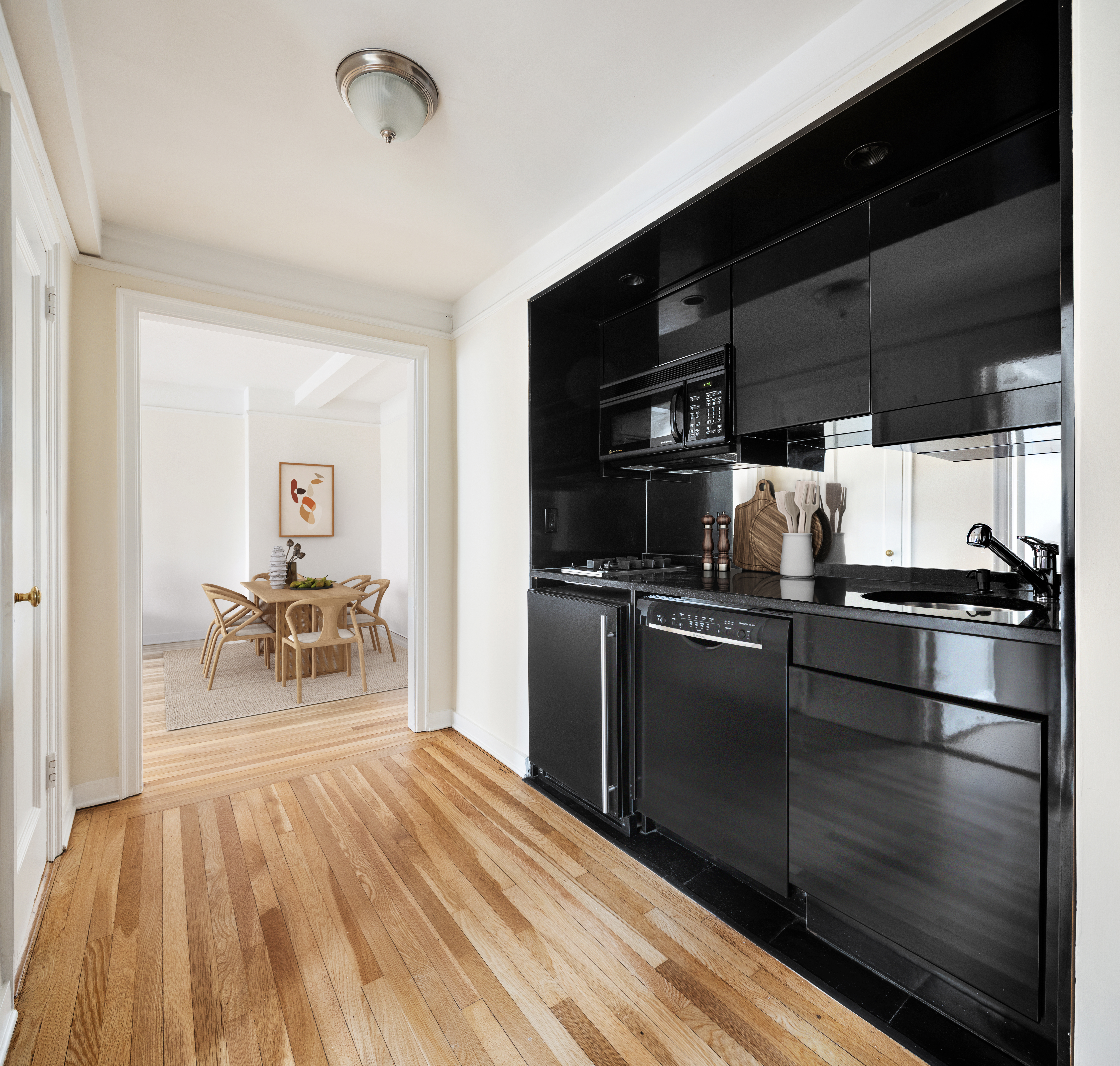 205 East 78th Street, Unit 14C Manhattan, NY 10075 - Photo 3 of 12 a kitchen with a refrigerator and a table
