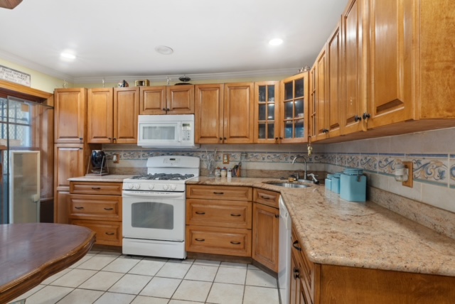 419 Clermont Avenue Brooklyn, NY 11238 - Photo 10 of 14 a kitchen with kitchen island granite countertop stainless steel appliances a stove sink and microwave