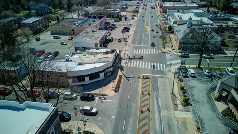 a front view of a house with cars parked