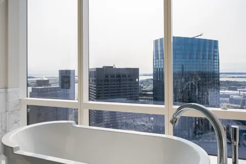 a bedroom with a large bed and a large window