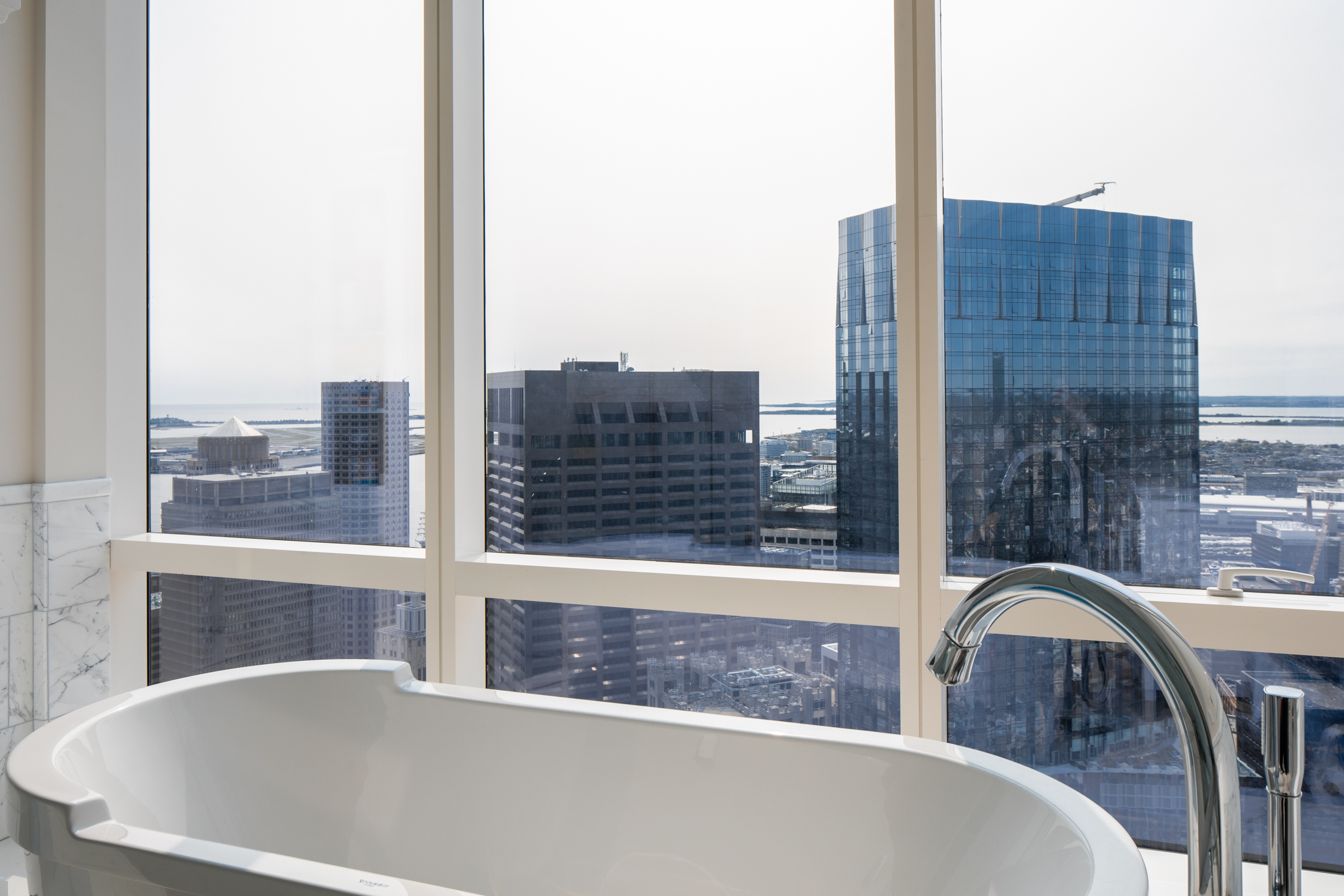 1 Franklin Street, Unit PH2D Boston, MA 02110 - Photo 22 of 26 a view of balcony with a large window and couch