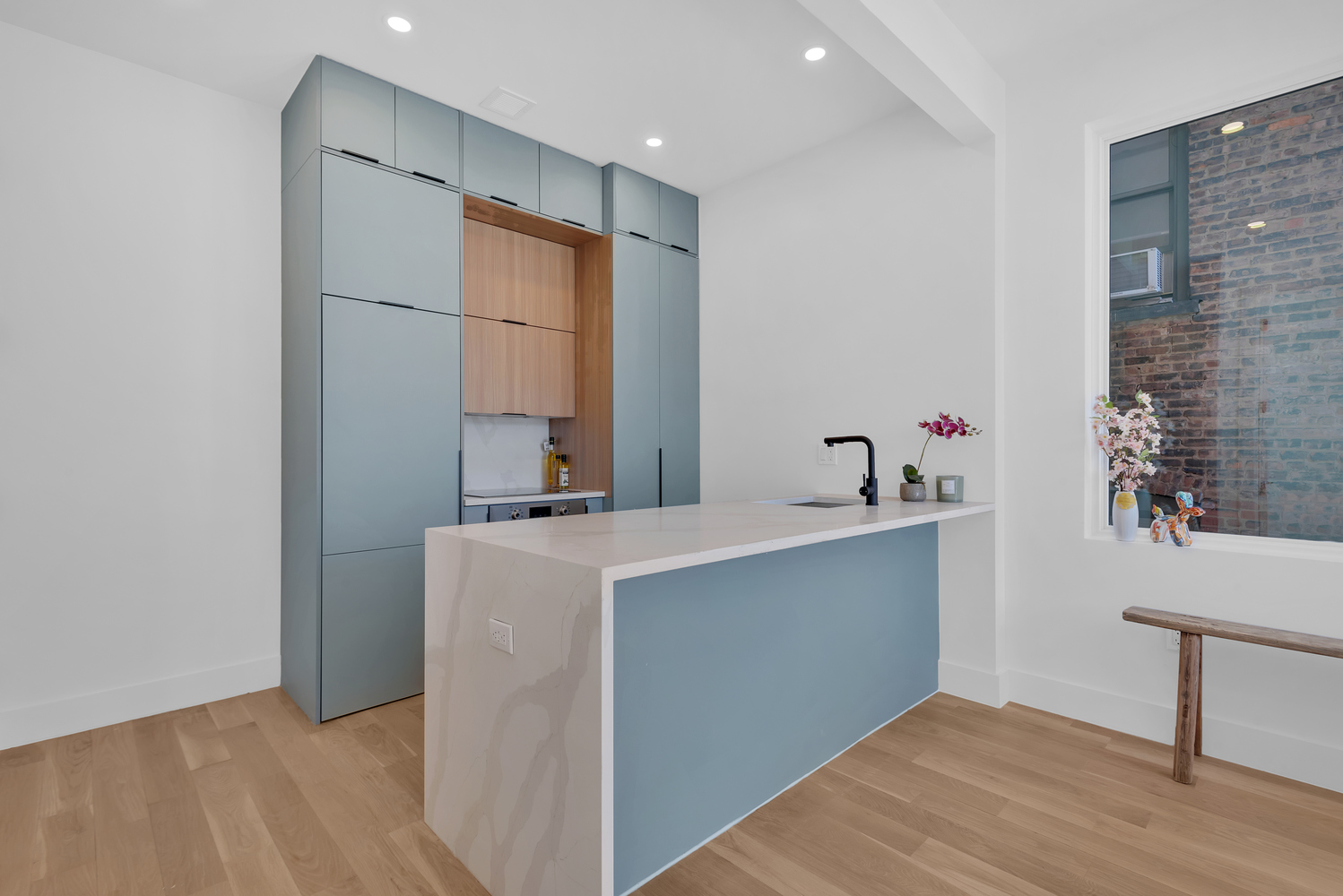 97 Seigel Street, Unit 3B Brooklyn, NY 11206 - Photo 6 of 8 a room with a sink cabinets and wooden floor