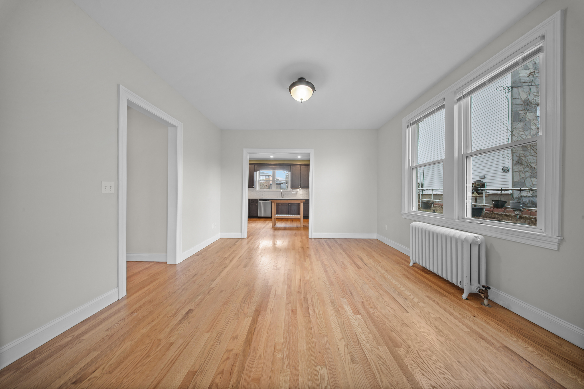 52-19 69th Street Queens, NY 11378 - Photo 14 of 35 wooden floor in an empty room with a window