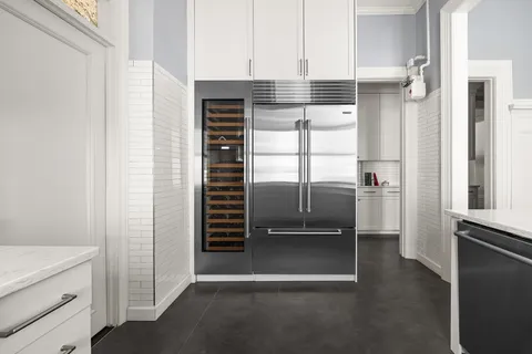 a kitchen with white cabinets and white appliances