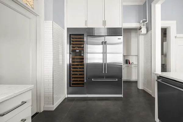 a kitchen with white cabinets and white appliances