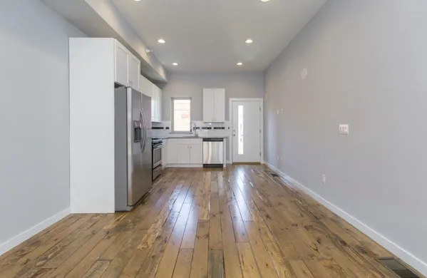 a view of kitchen with sink and wooden floor