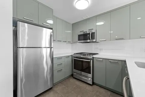 a kitchen with stainless steel appliances granite countertop a refrigerator and a microwave