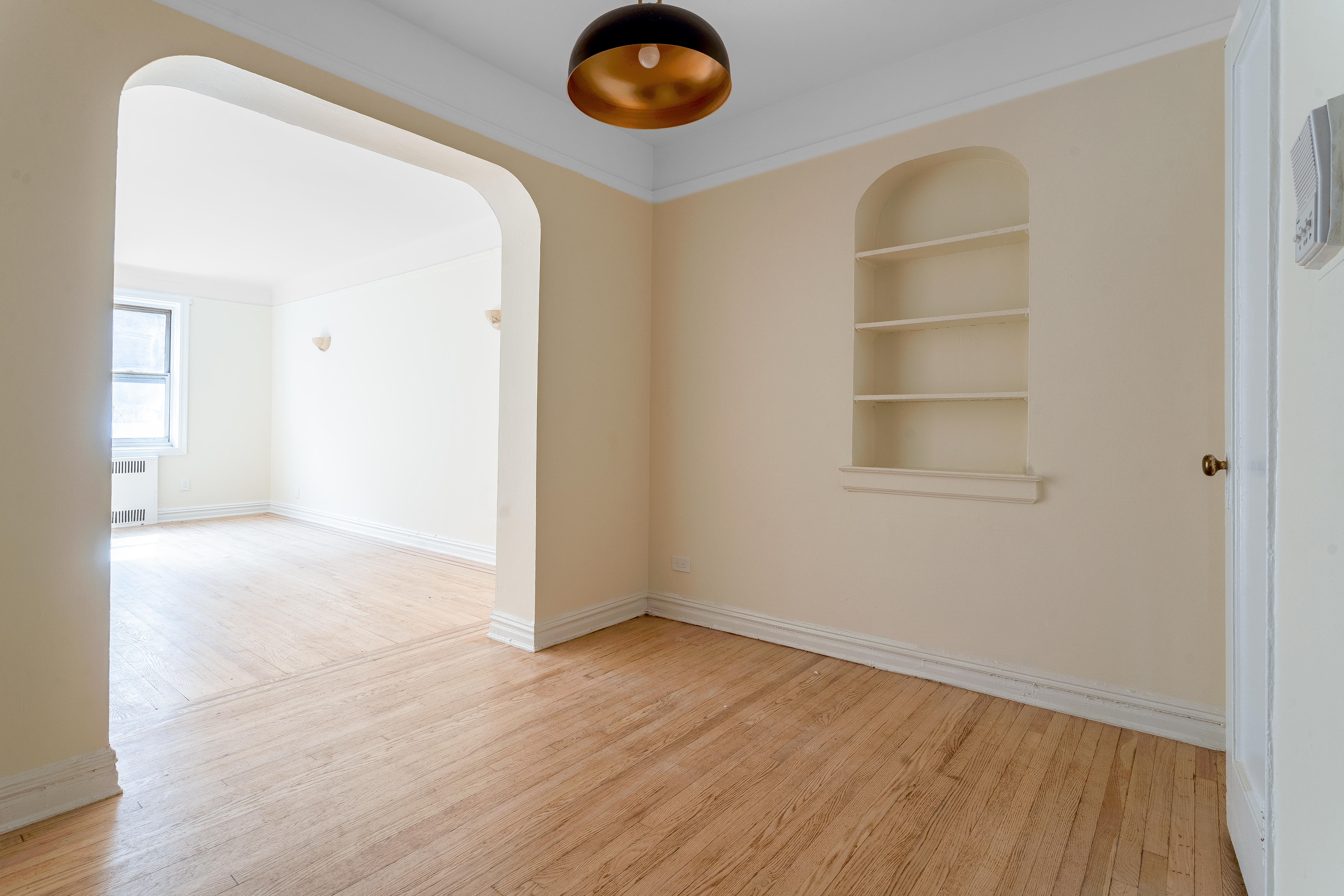 40 Tehama Street, Unit 2E Brooklyn, NY 11218 - Photo 3 of 12 an empty room with wooden floor and windows