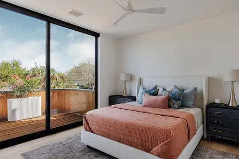 a bathroom with a double vanity sink and mirror with toilet