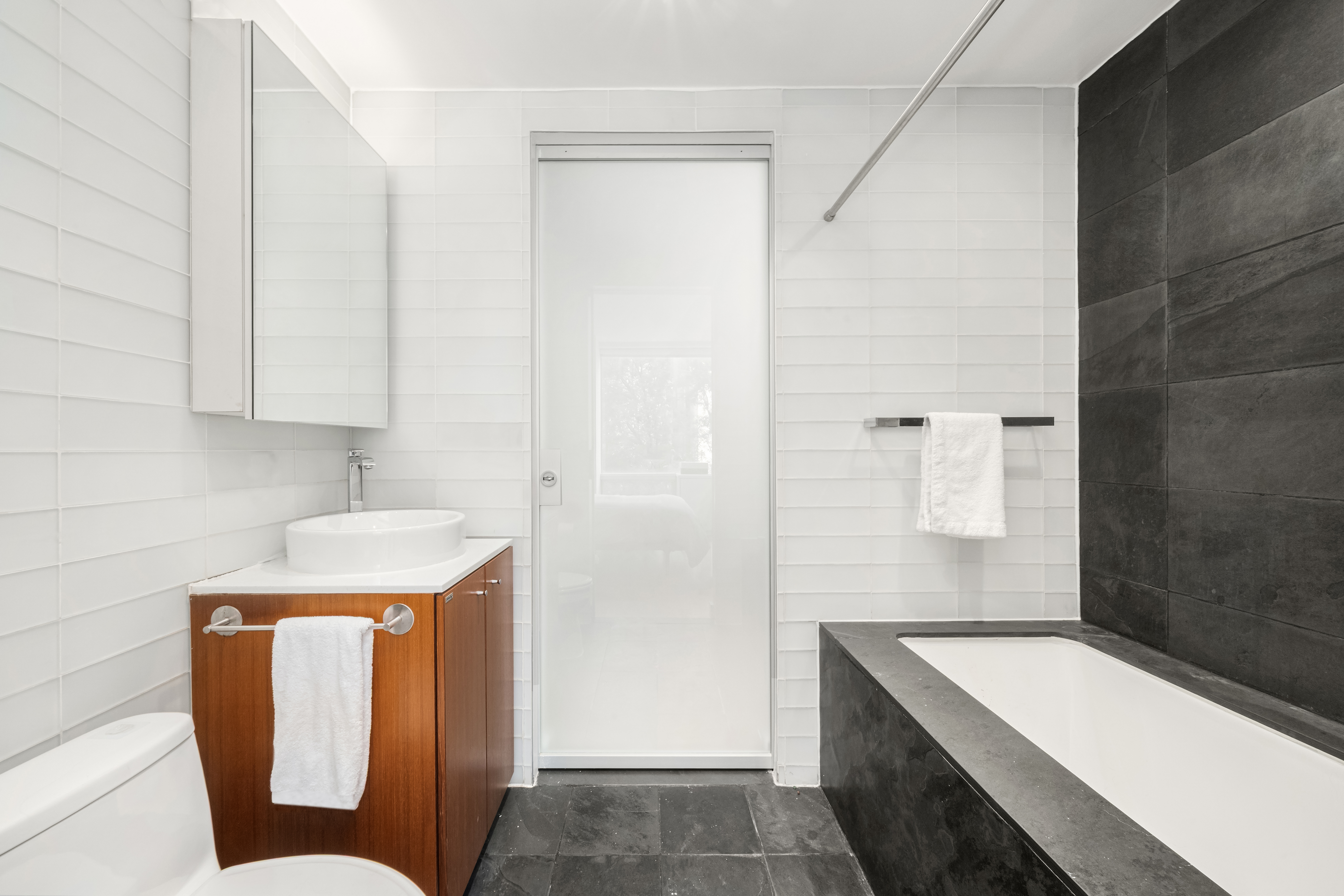 425 East 13th Street, Unit 4C Manhattan, NY 10009 - Photo 9 of 14 a bathroom with a sink toilet and tub