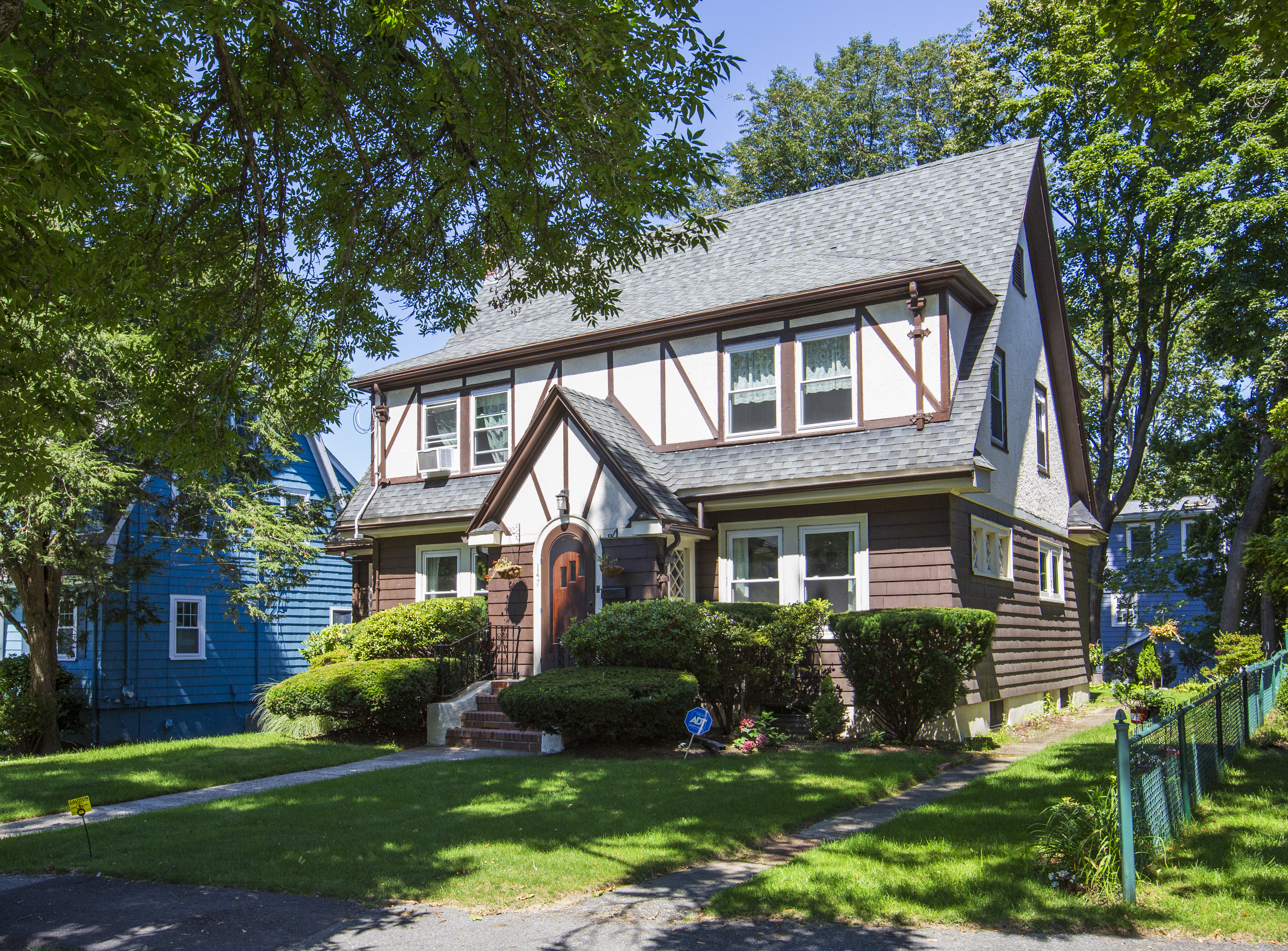 147 Oliver Road Waban, MA 02468 - Photo 2 of 6 a front view of a house with a yard and trees