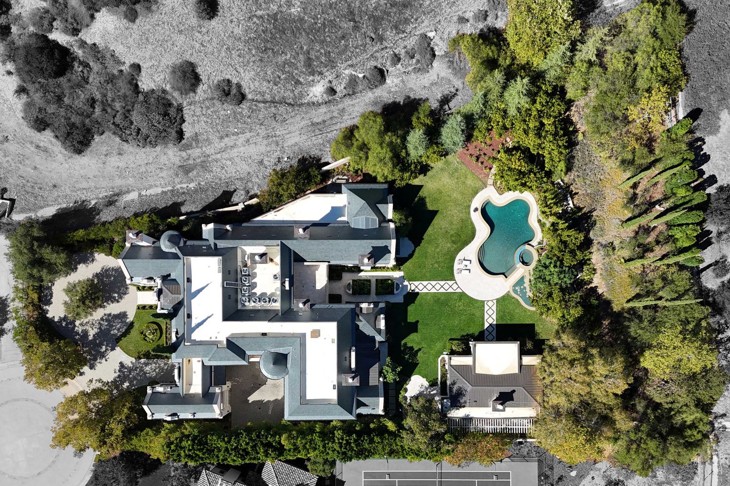 an aerial view of a house with a swimming pool and outdoor seating