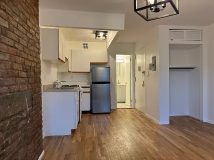 a kitchen with a refrigerator and cabinets