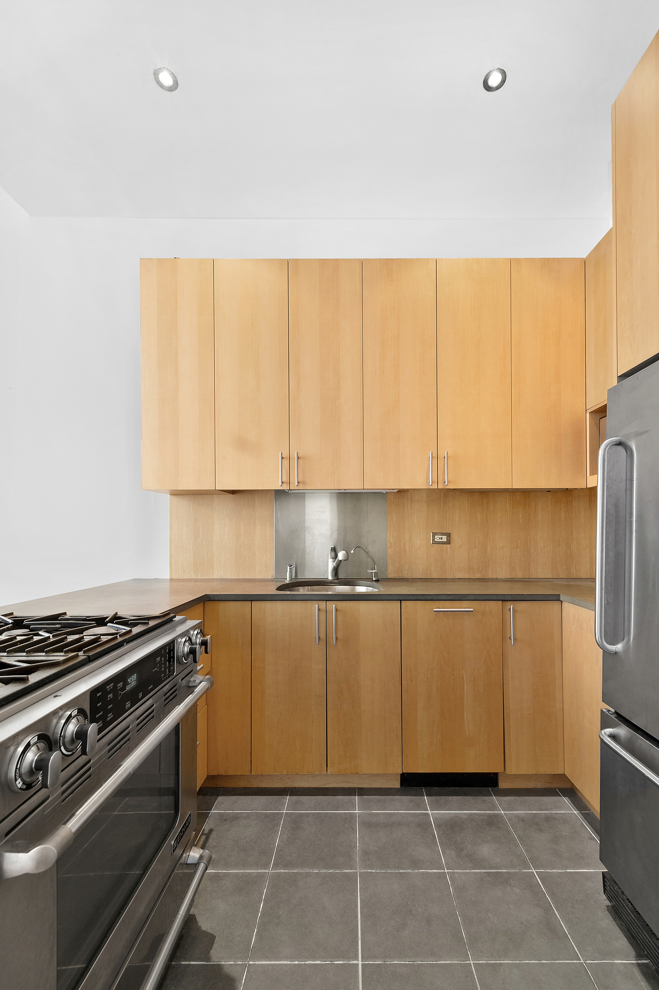 250 Mercer Street, Unit D603 Manhattan, NY 10012 - Photo 5 of 20 a kitchen with a white cabinets and appliances