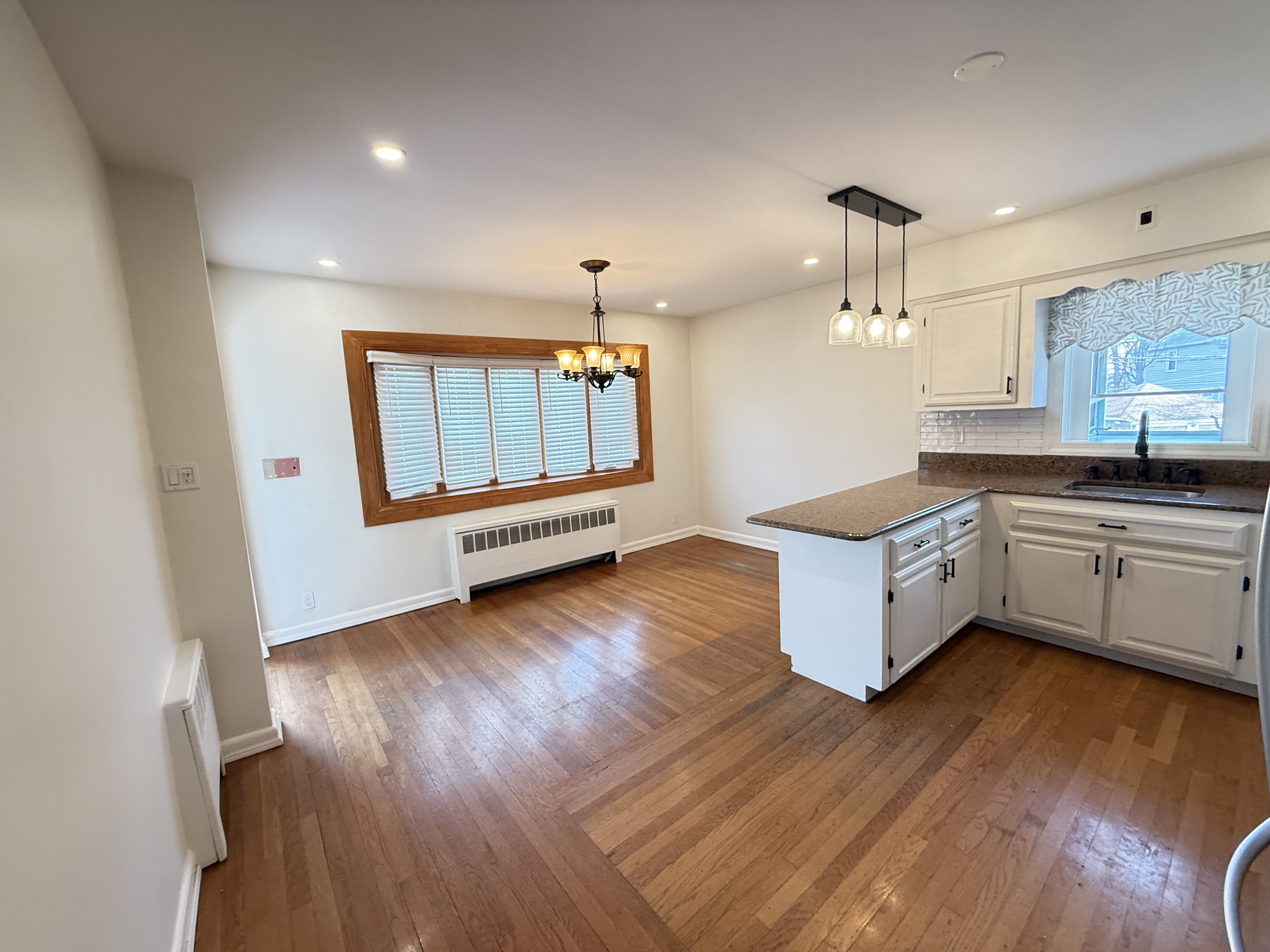 3236 Country Club Road Bronx, NY 10465 - Photo 7 of 22 a kitchen with granite countertop a sink cabinets and wooden floor