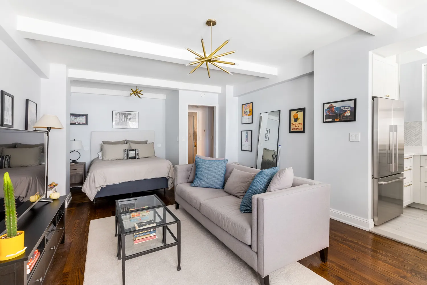 a living room with furniture and a chandelier