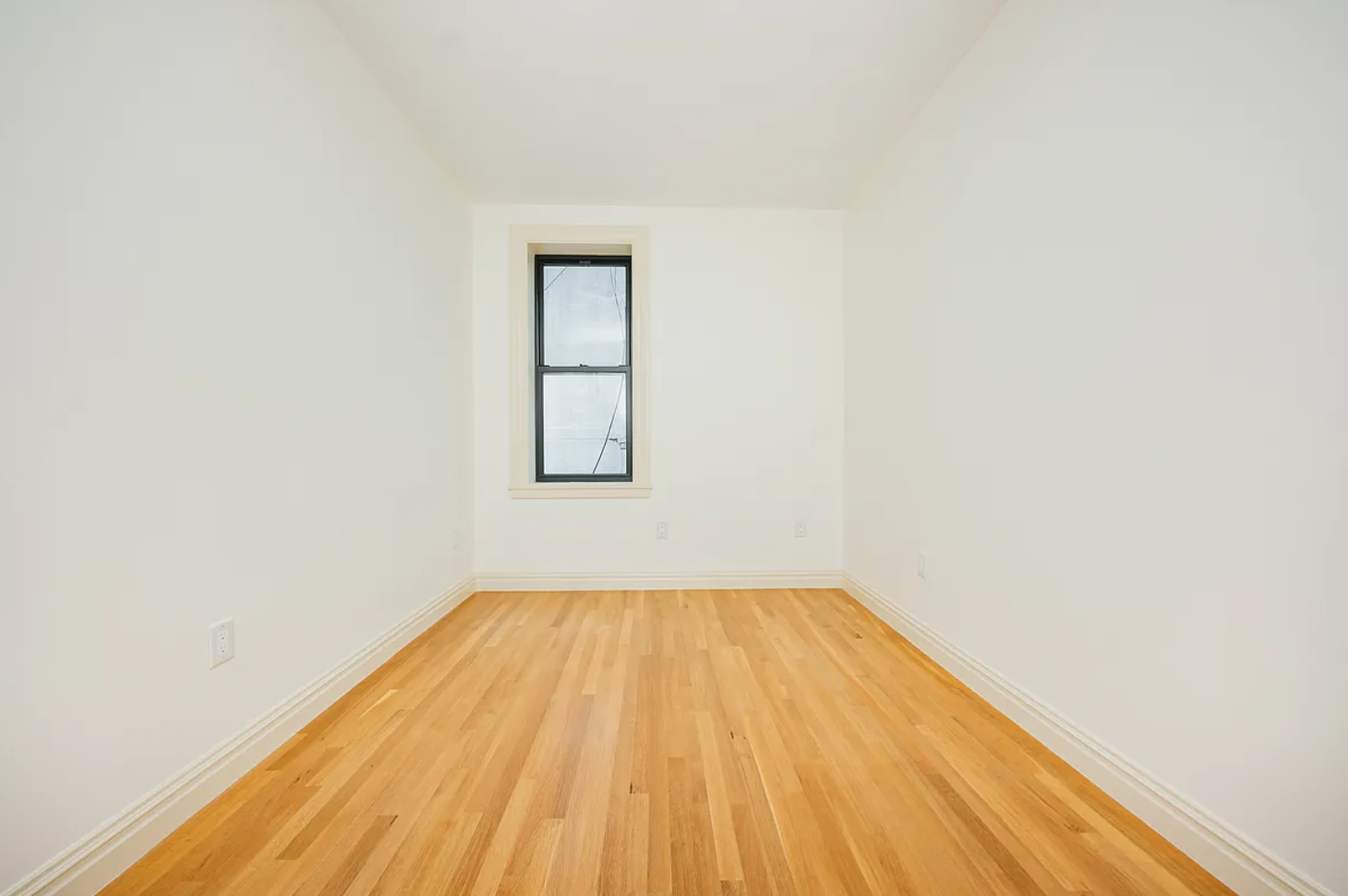 68-38 Forest Avenue, Unit 3R Queens, NY 11385 - Photo 12 of 15 a view of a room with wooden floor and brick walls