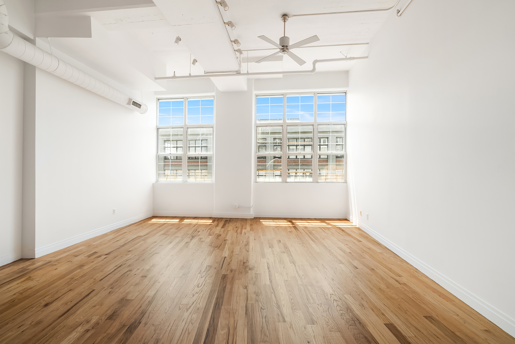 689 Myrtle Avenue, Unit 4E Brooklyn, NY 11205 - Photo 5 of 21 a view of an empty room with wooden floor and a window