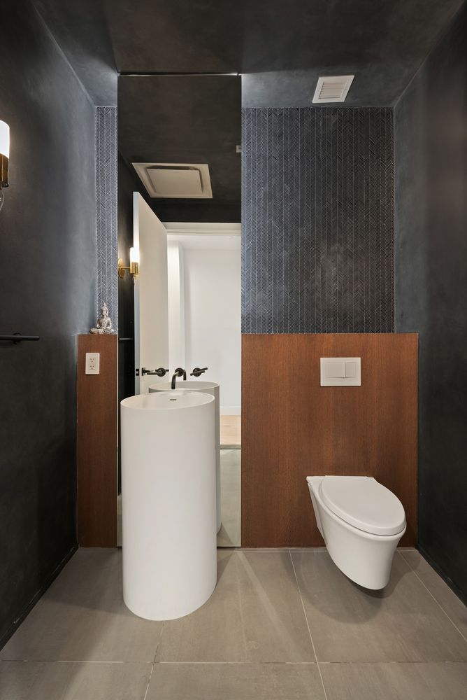 111 Mercer Street, Unit 4 Manhattan, NY 10012 - Photo 9 of 12 a bathroom with a sink a toilet and mirror