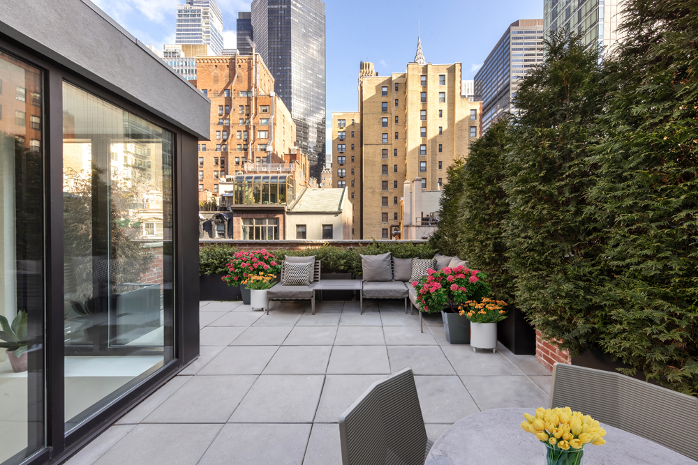 130 East 38th Street Manhattan, NY 10016 - Photo 3 of 16 a view of a terrace with chairs and potted plants