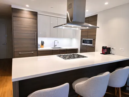 a kitchen with a sink cabinets and stainless steel appliances