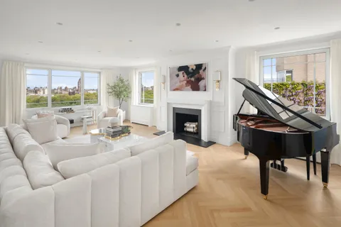 a living room with furniture a fireplace and a table