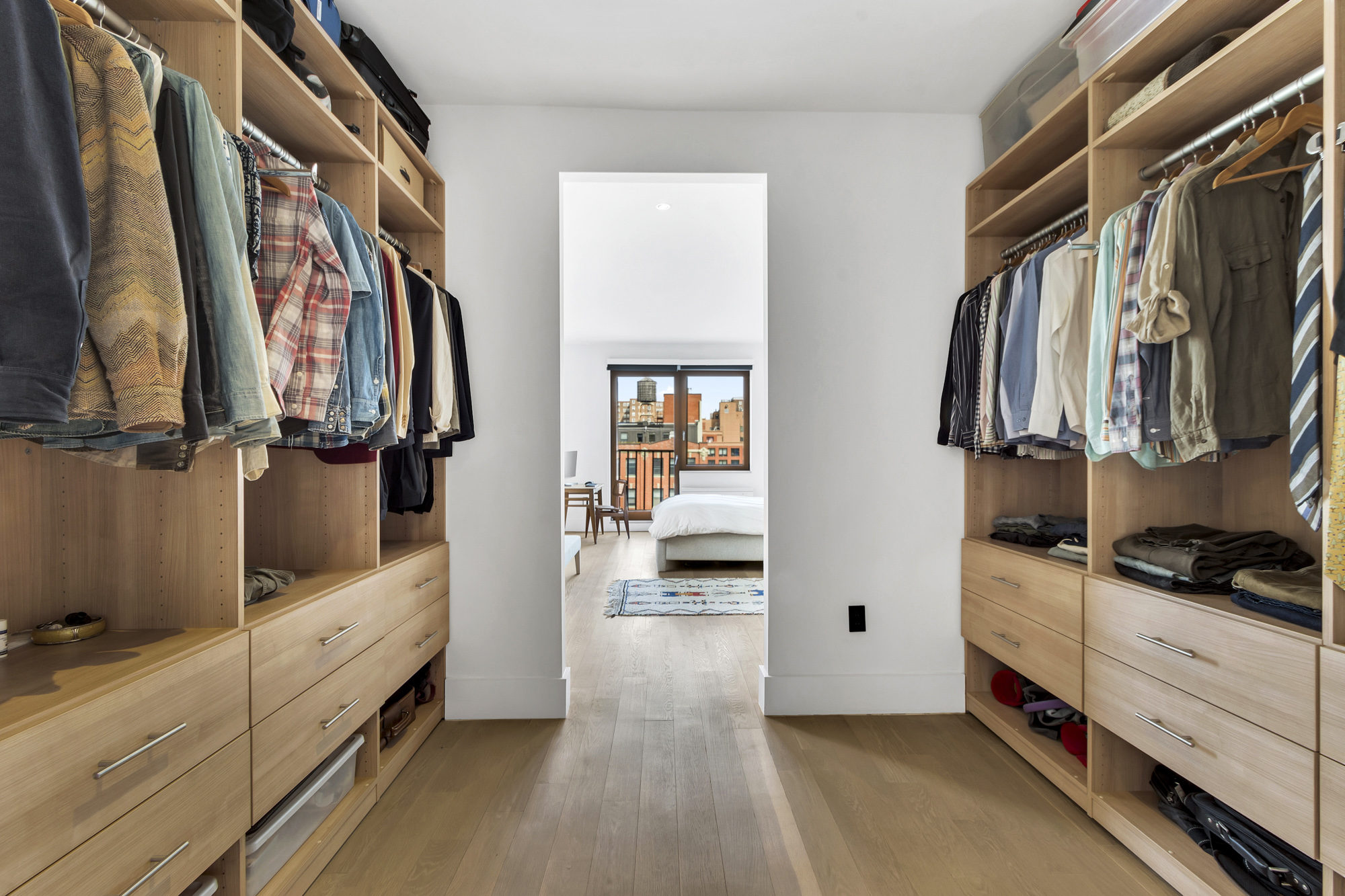 267 West 124th Street, Unit 6A Manhattan, NY 10027 - Photo 15 of 24 a view of walk in closet with clothes and shoes