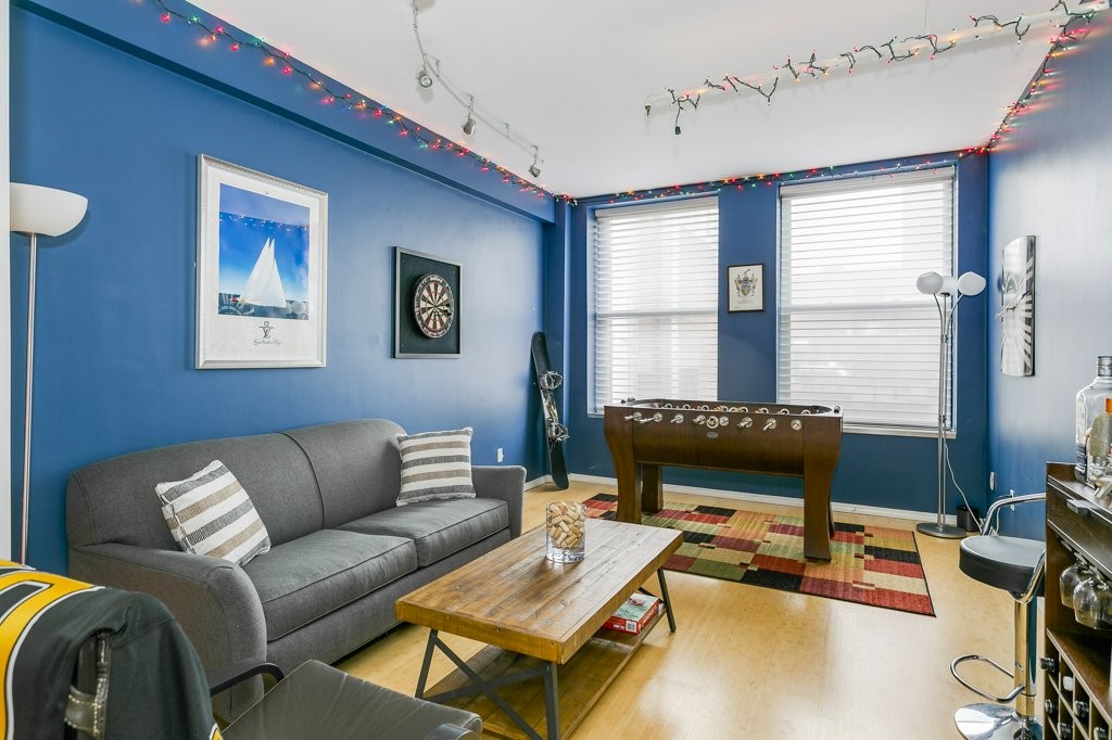 453 Washington Street, Unit 5D Boston, MA 02111 - Photo 6 of 17 a living room with furniture a flat screen tv and a window