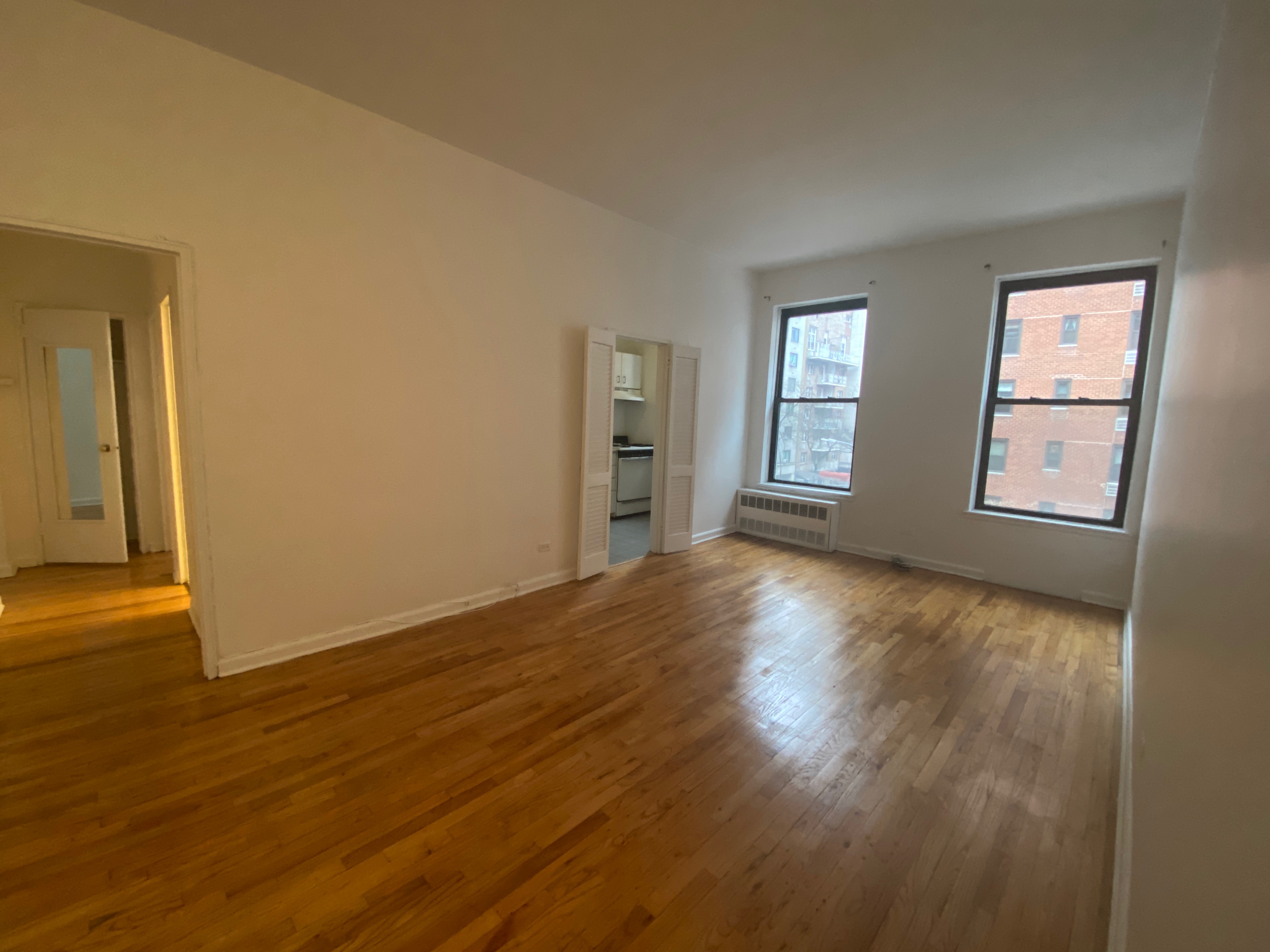 1240 Lexington Avenue, Unit 34 Manhattan, NY 10028 - Photo 1 of 11 a view of empty room with wooden floor and fan