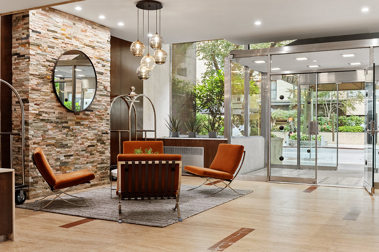 330 East 49th Street, Unit 9C Manhattan, NY 10017 - Photo 10 of 13 a living room with furniture a floor to ceiling window and outdoor view