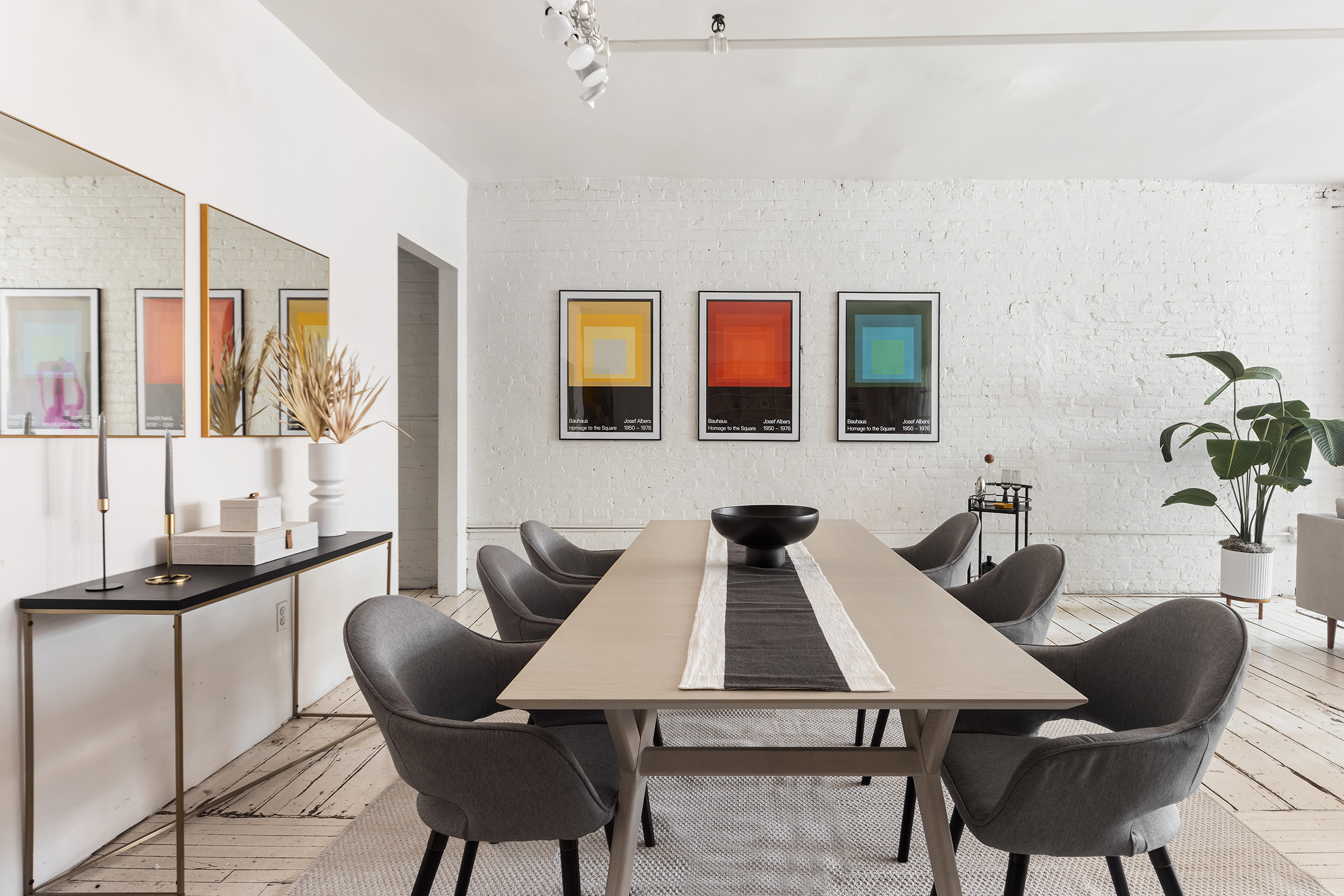 10 Leonard Street, Unit 6N Manhattan, NY 10013 - Photo 3 of 12 a view of a dining room with furniture and wooden floor
