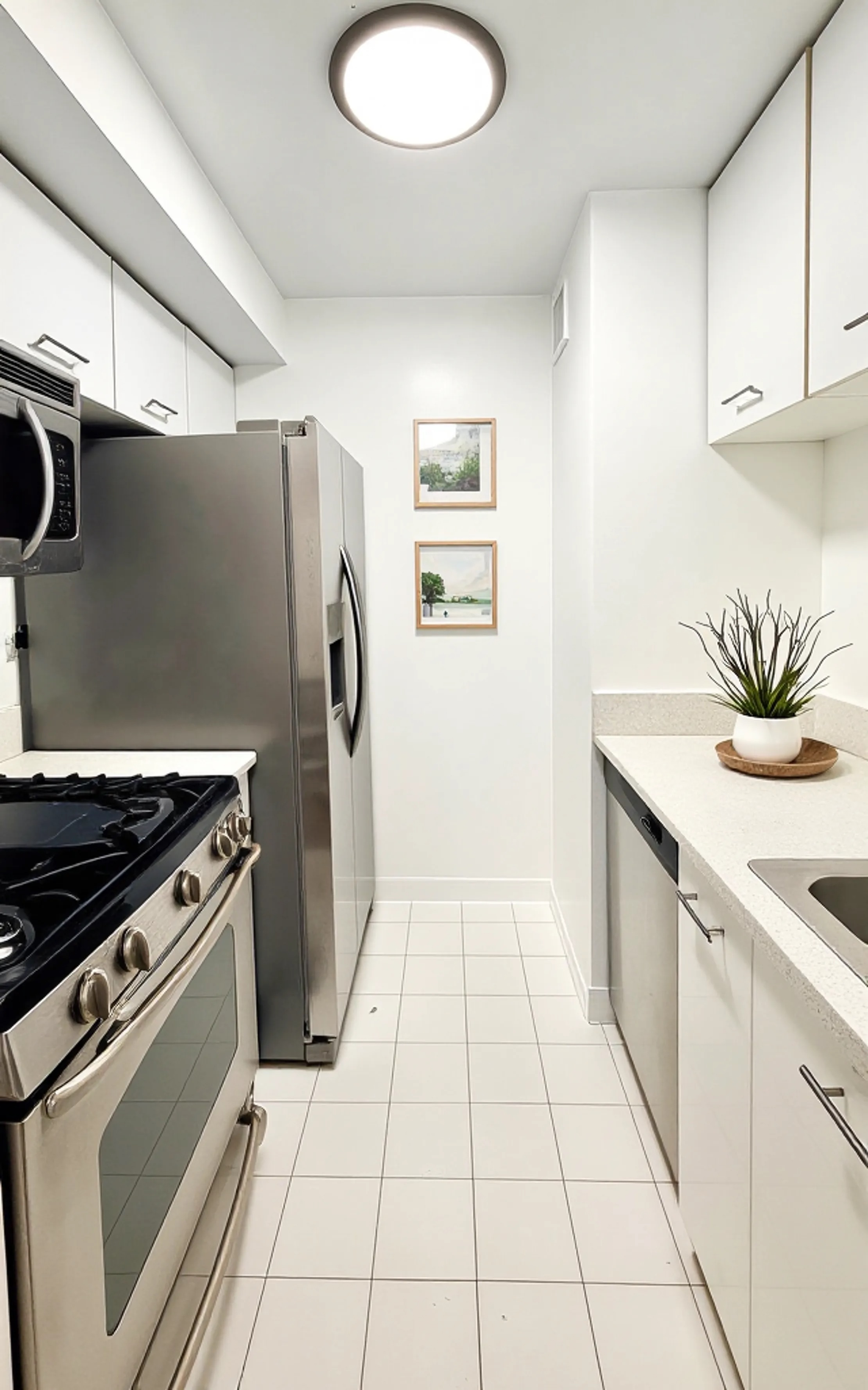 445 5th Avenue, Unit 23D Manhattan, NY 10016 - Photo 7 of 15 a kitchen with a stove and a refrigerator