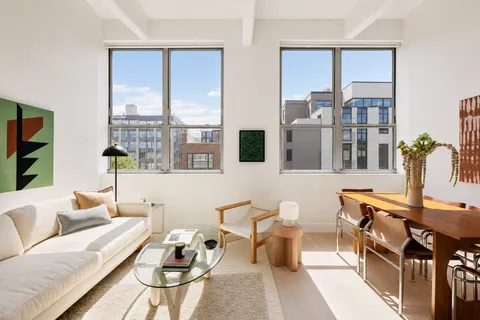 a living room with furniture and large windows