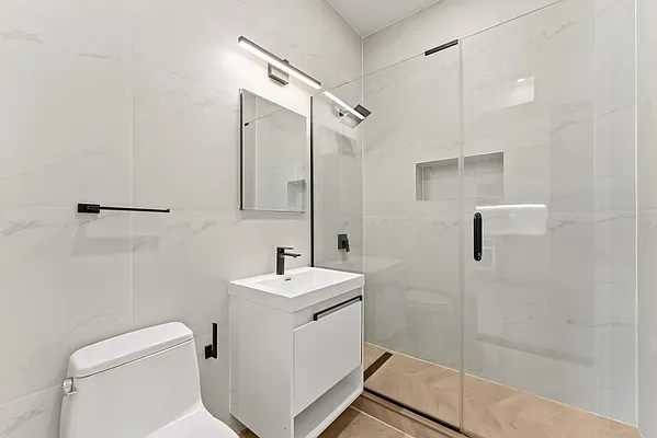 a bathroom with a toilet sink and shower