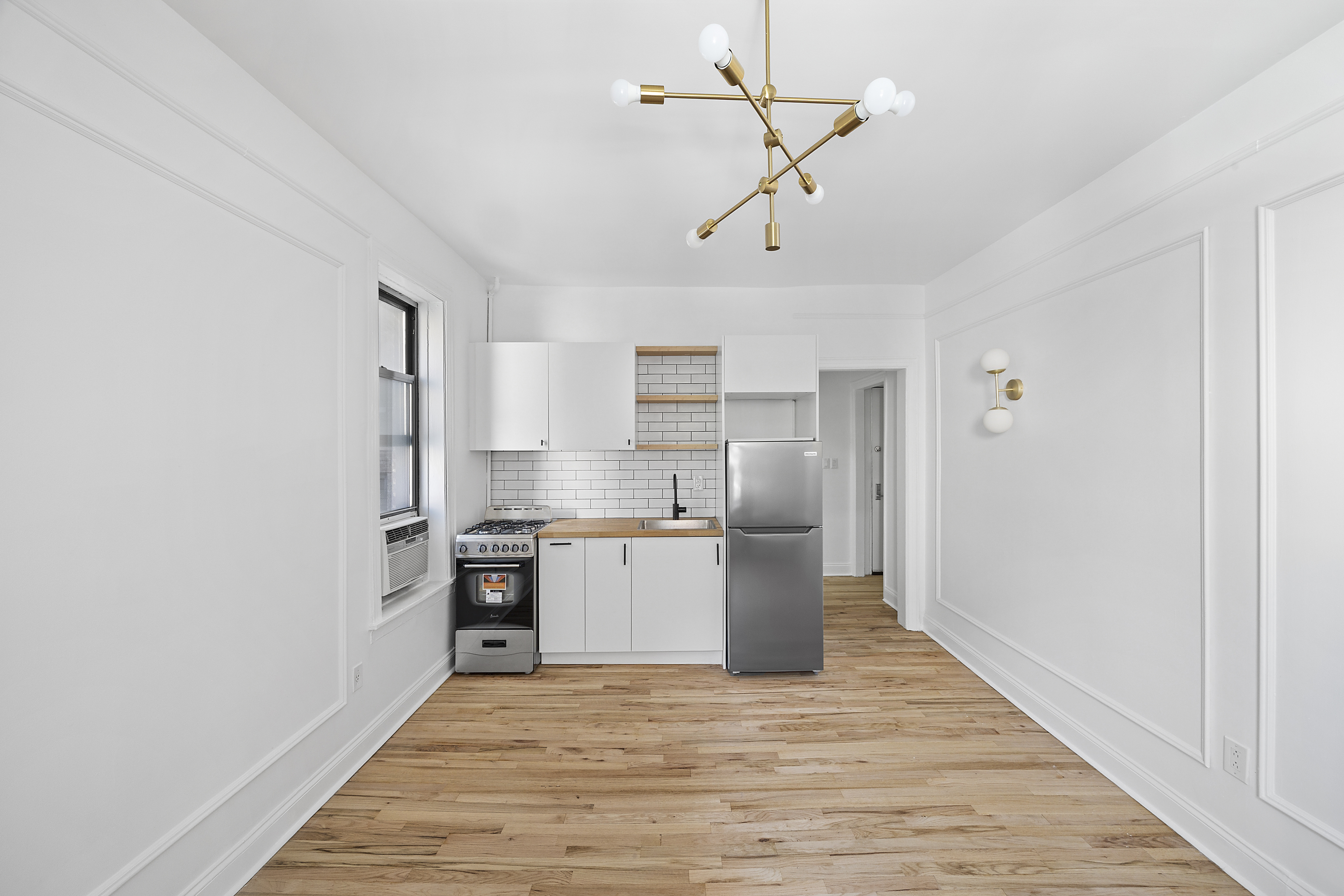 48 West 138th Street, Unit 2F Manhattan, NY 10037 - Photo 5 of 10 a kitchen with stainless steel appliances granite countertop a refrigerator and a stove top oven